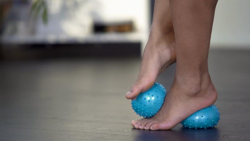 person using massage balls on the feet - decorative image in an article: here's why your plantar fasciitis won't go away