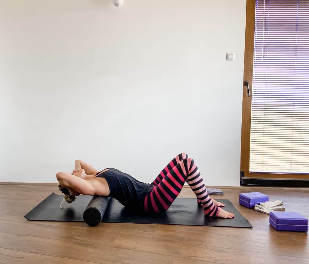 woman performing thoracic extension on a foam roller